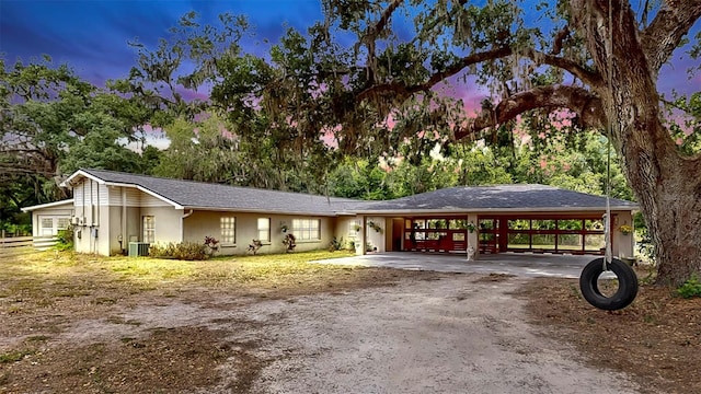 view of property's community with driveway and an attached carport