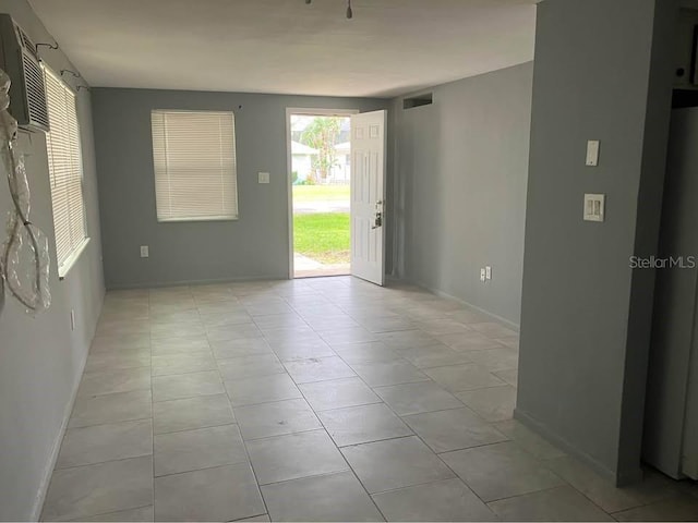 interior space with visible vents, baseboards, and light tile patterned flooring