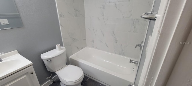 bathroom featuring vanity, a textured wall, toilet, and shower / washtub combination