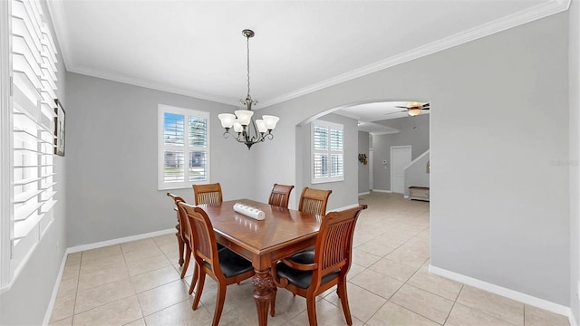 dining space with plenty of natural light, arched walkways, stairs, and crown molding