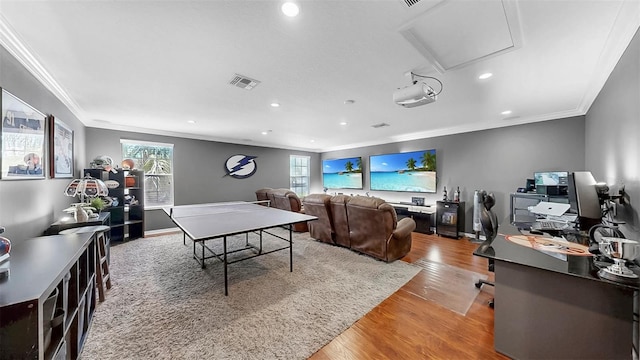 recreation room featuring visible vents, ornamental molding, wood finished floors, and recessed lighting