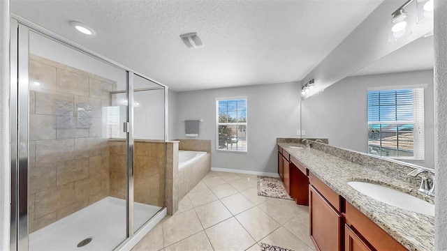 full bath featuring a sink, double vanity, a shower stall, and a bath
