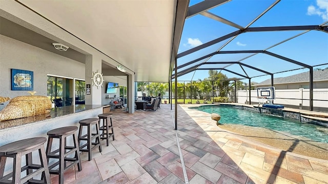 view of pool featuring a patio area, outdoor dry bar, a hot tub, glass enclosure, and a fenced in pool
