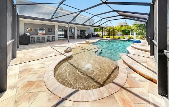 outdoor pool featuring a lanai and a patio area