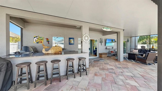 view of patio with outdoor wet bar
