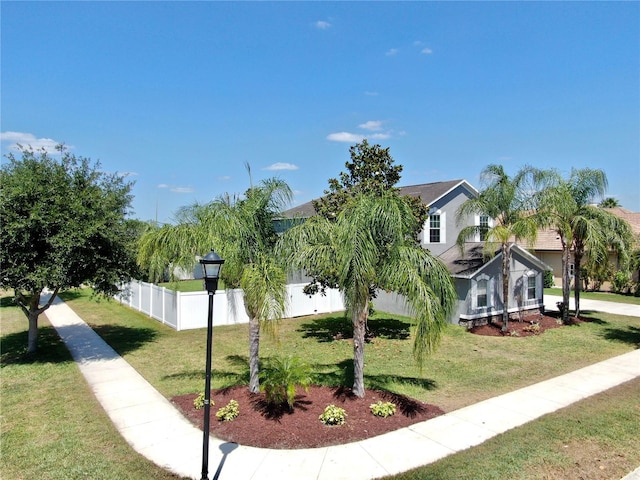 exterior space featuring a lawn and fence