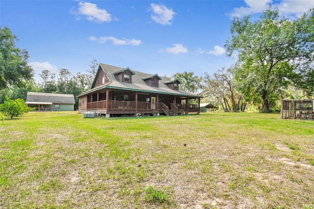 rear view of house featuring a lawn and a deck