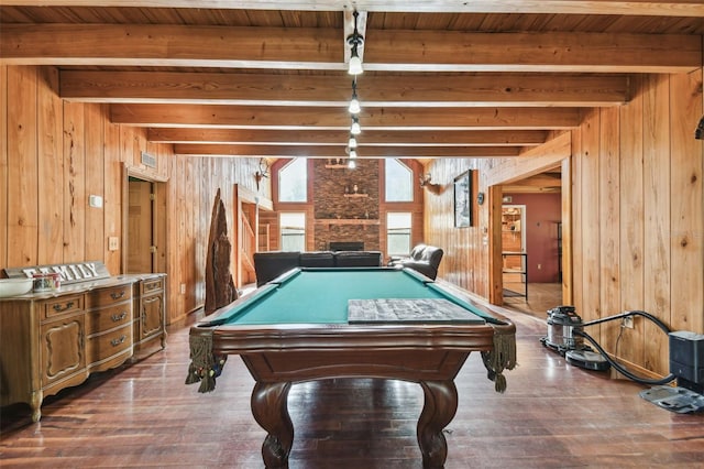 game room with wooden ceiling, beam ceiling, wooden walls, and hardwood / wood-style flooring