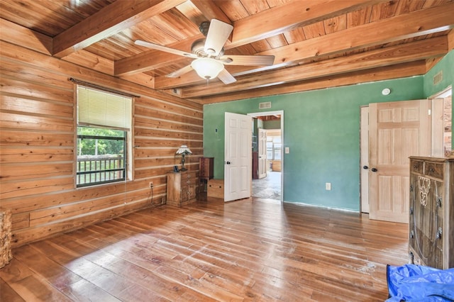 interior space with wooden ceiling, beamed ceiling, a ceiling fan, and hardwood / wood-style floors