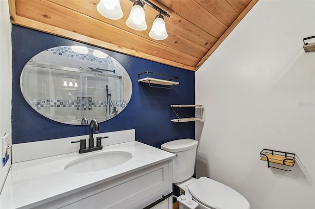 bathroom with toilet, wood ceiling, a shower stall, vaulted ceiling, and vanity