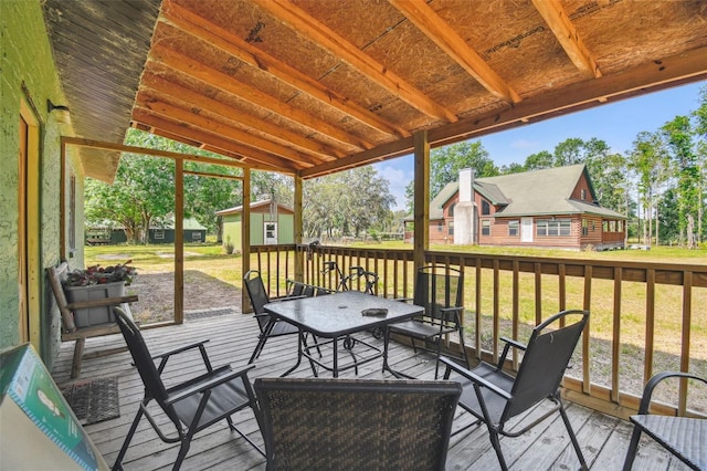 deck with a lawn and an outbuilding