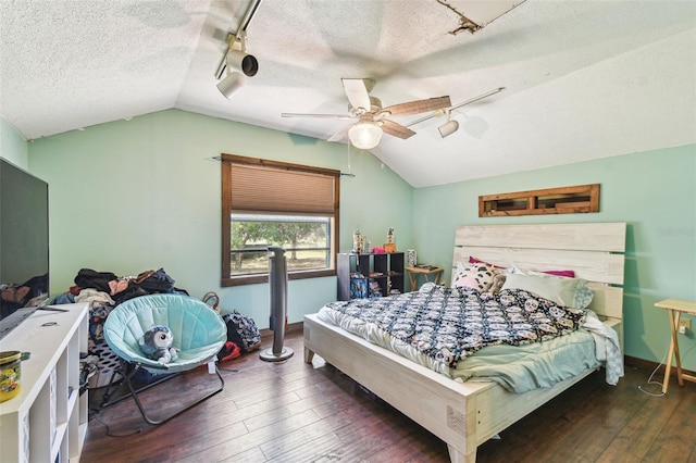 bedroom featuring hardwood / wood-style floors, track lighting, a textured ceiling, ceiling fan, and lofted ceiling