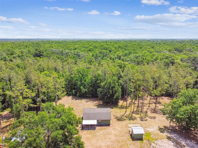 drone / aerial view featuring a wooded view