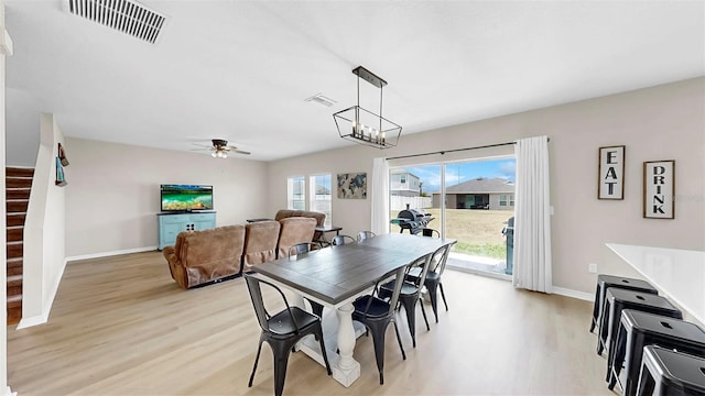 dining room with visible vents, light wood-style flooring, ceiling fan, and baseboards