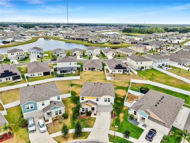 drone / aerial view with a water view and a residential view