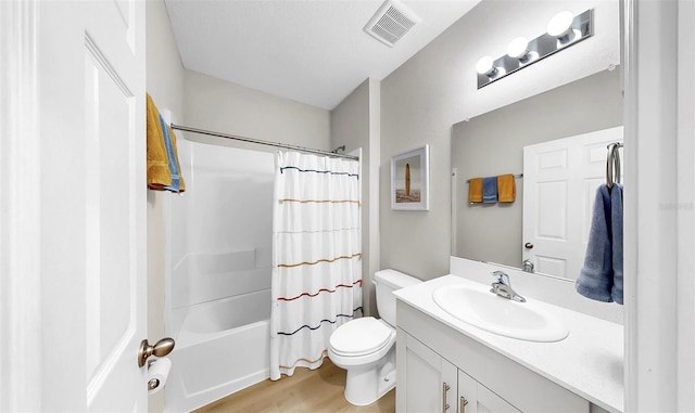 bathroom with visible vents, wood finished floors, vanity, toilet, and shower / bath combo with shower curtain