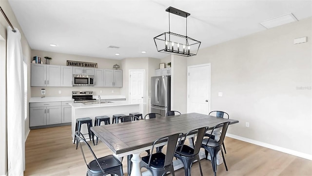 dining area featuring visible vents, baseboards, light wood finished floors, a notable chandelier, and recessed lighting