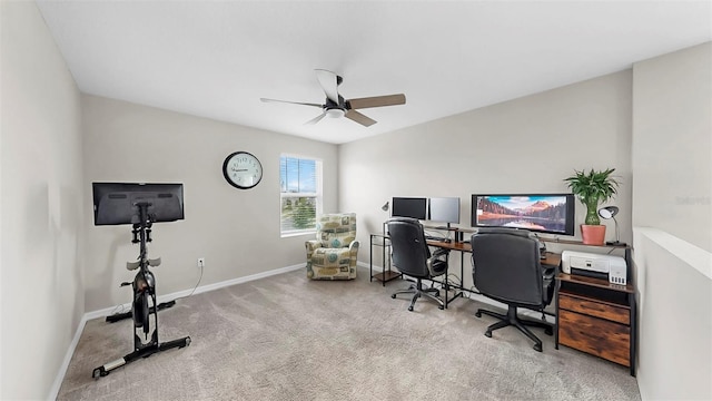office space featuring baseboards, ceiling fan, and carpet
