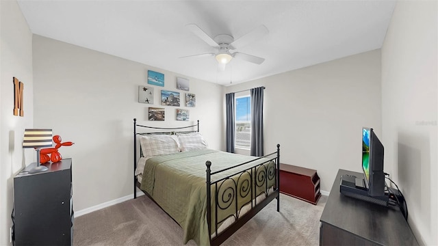 bedroom featuring baseboards, ceiling fan, and carpet