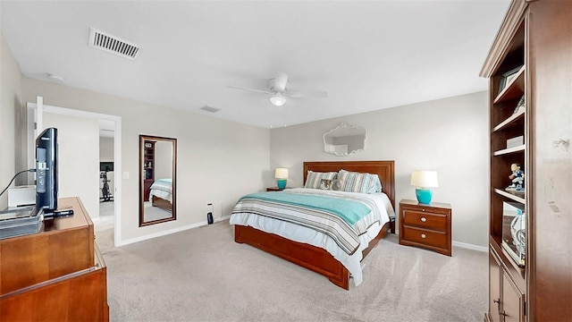 bedroom featuring baseboards, visible vents, light carpet, and ceiling fan