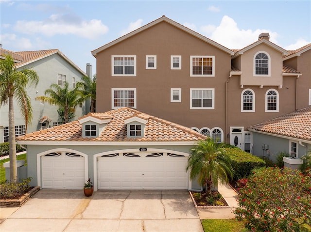 1750 Arabian Ln, Palm Harbor, FL 34685 - view of front of house with concrete driveway, stucco siding, and a tiled roof