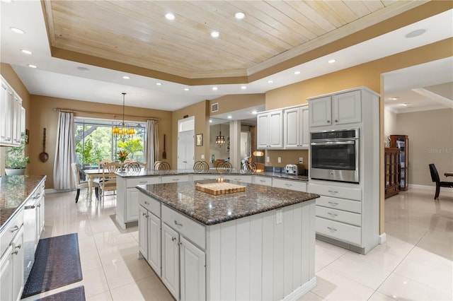 1750 Arabian Ln, Palm Harbor, FL 34685 - kitchen featuring stainless steel oven, a raised ceiling, wood ceiling, a peninsula, and recessed lighting