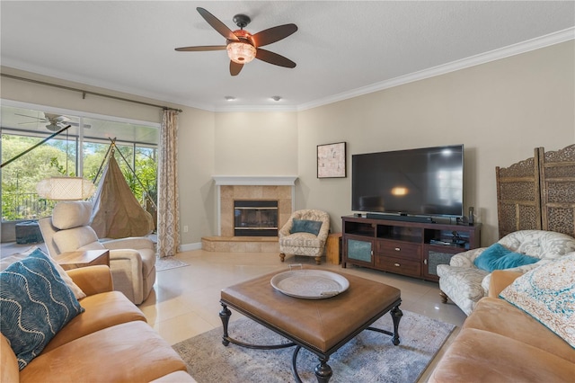 1750 Arabian Ln, Palm Harbor, FL 34685 - tiled living area with ceiling fan, ornamental molding, a tile fireplace, and baseboards