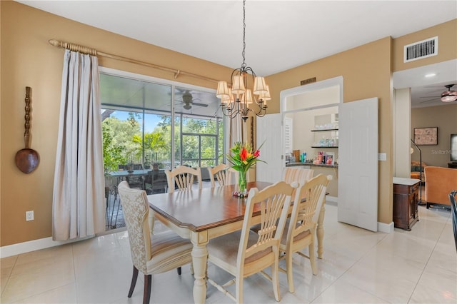 1750 Arabian Ln, Palm Harbor, FL 34685 - dining room featuring a ceiling fan, baseboards, light tile patterned floors, and a chandelier