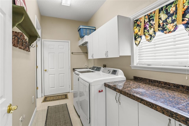 1750 Arabian Ln, Palm Harbor, FL 34685 - laundry room with cabinet space, separate washer and dryer, light tile patterned floors, and baseboards