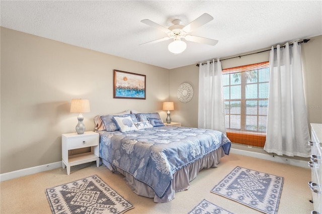 1750 Arabian Ln, Palm Harbor, FL 34685 - bedroom featuring light colored carpet, a textured ceiling, ceiling fan, and baseboards