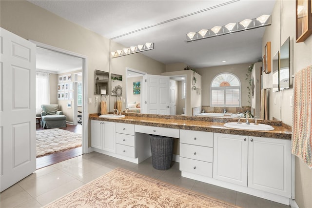 1750 Arabian Ln, Palm Harbor, FL 34685 - bathroom featuring tile patterned floors, double vanity, and a bath