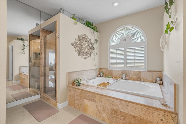 1750 Arabian Ln, Palm Harbor, FL 34685 - full bathroom featuring a bath, a shower stall, and tile patterned flooring