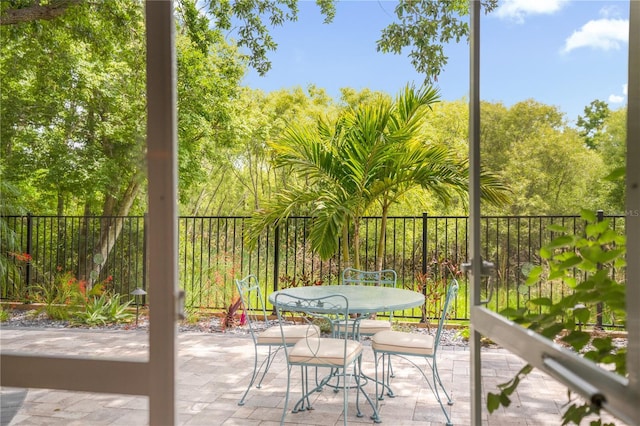 1750 Arabian Ln, Palm Harbor, FL 34685 - balcony with a patio and outdoor dining area