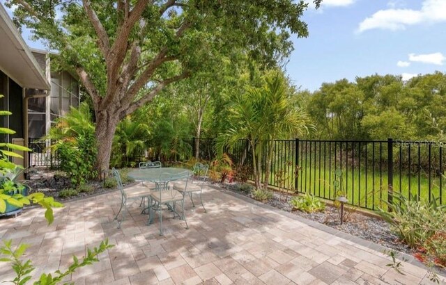 1750 Arabian Ln, Palm Harbor, FL 34685 - view of patio featuring fence and outdoor dining space