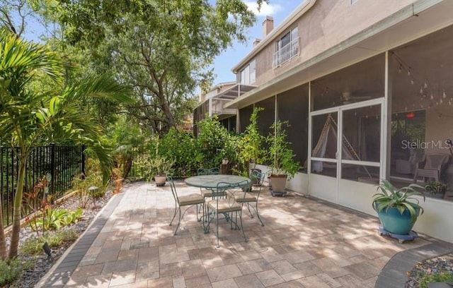 1750 Arabian Ln, Palm Harbor, FL 34685 - view of patio / terrace with outdoor dining area and fence