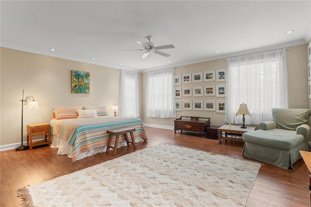 1750 Arabian Ln, Palm Harbor, FL 34685 - bedroom featuring wood finished floors, recessed lighting, baseboards, a textured ceiling, and a ceiling fan