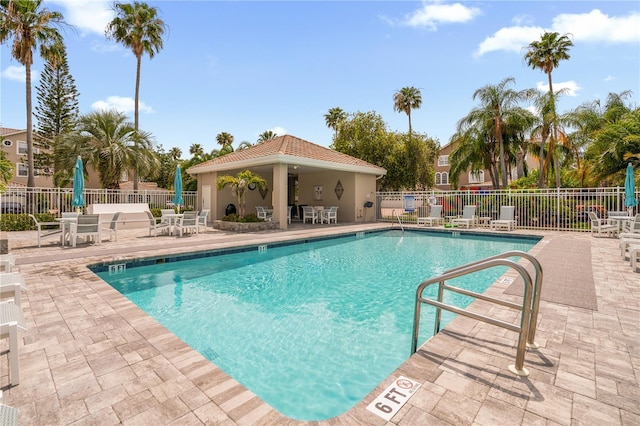 1750 Arabian Ln, Palm Harbor, FL 34685 - community pool featuring a patio area, fence, and outdoor dining space