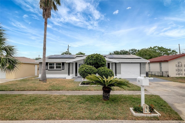 1516 Roundtree Rd, Holiday, FL 34690 - single story home with a garage, fence, a front yard, roof mounted solar panels, and concrete driveway