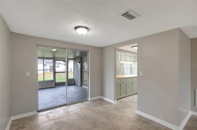 1516 Roundtree Rd, Holiday, FL 34690 - doorway to outside featuring baseboards and visible vents