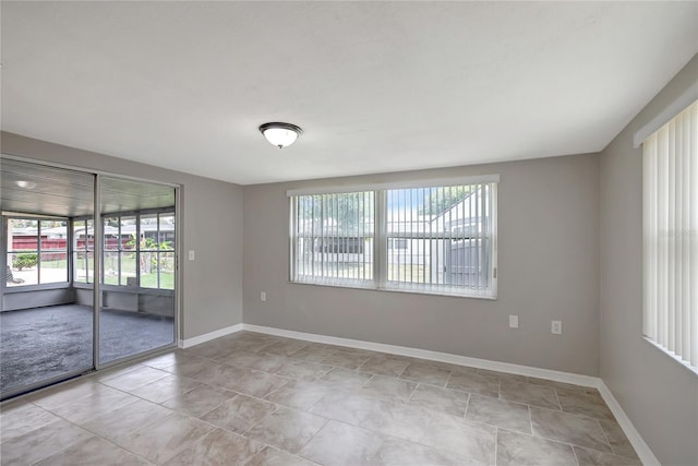 1516 Roundtree Rd, Holiday, FL 34690 - empty room with baseboards and a wealth of natural light