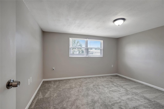 1516 Roundtree Rd, Holiday, FL 34690 - carpeted spare room featuring baseboards and a textured ceiling
