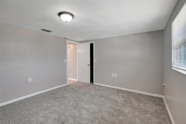 1516 Roundtree Rd, Holiday, FL 34690 - carpeted spare room with baseboards and visible vents