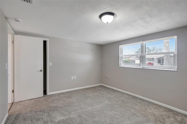 1516 Roundtree Rd, Holiday, FL 34690 - empty room featuring baseboards, carpet flooring, a textured ceiling, and visible vents
