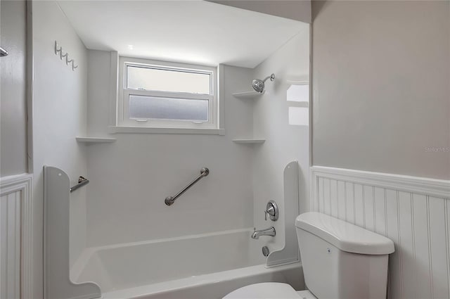 1516 Roundtree Rd, Holiday, FL 34690 - full bath with tub / shower combination, a wainscoted wall, and toilet