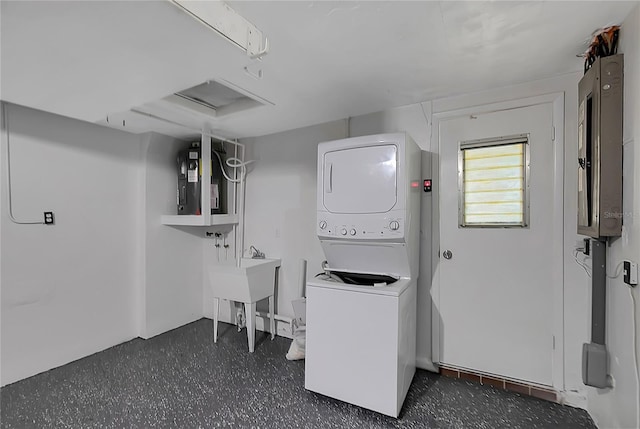 1516 Roundtree Rd, Holiday, FL 34690 - clothes washing area featuring stacked washer / drying machine and laundry area