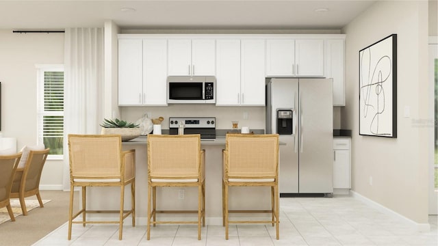 kitchen featuring stainless steel appliances, baseboards, and white cabinetry