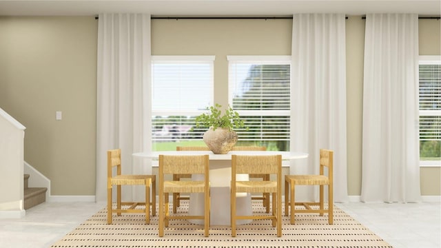 dining room featuring stairs, tile patterned floors, baseboards, and a healthy amount of sunlight