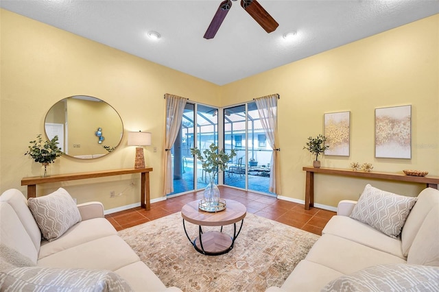 tiled living room with baseboards and a ceiling fan
