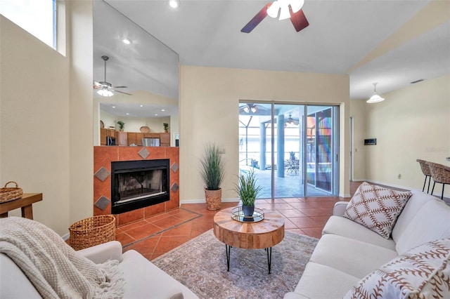 living area featuring a ceiling fan, recessed lighting, a tiled fireplace, and tile patterned flooring