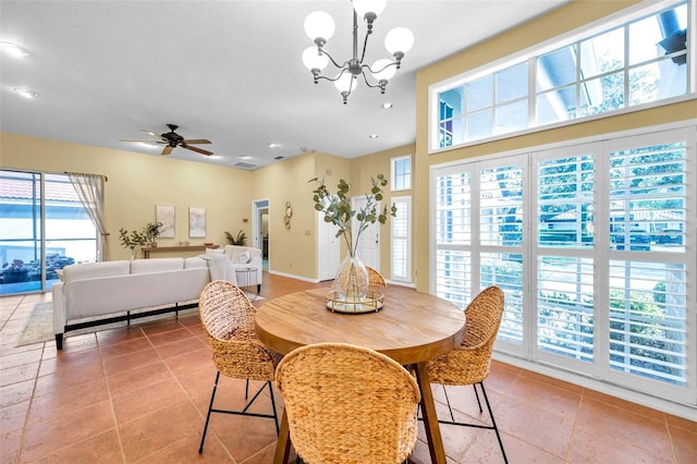 tiled dining space with recessed lighting, baseboards, and ceiling fan with notable chandelier